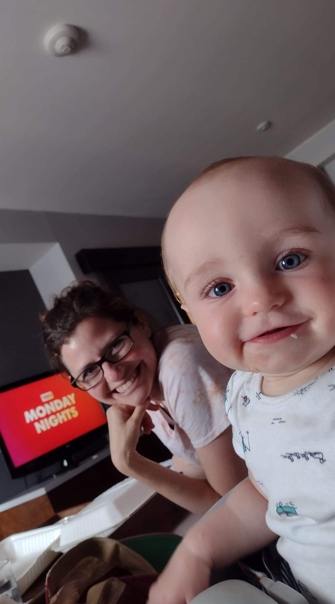 picture of Diana and Brooklyn smiling on the bed at the hotel on the honeymoon