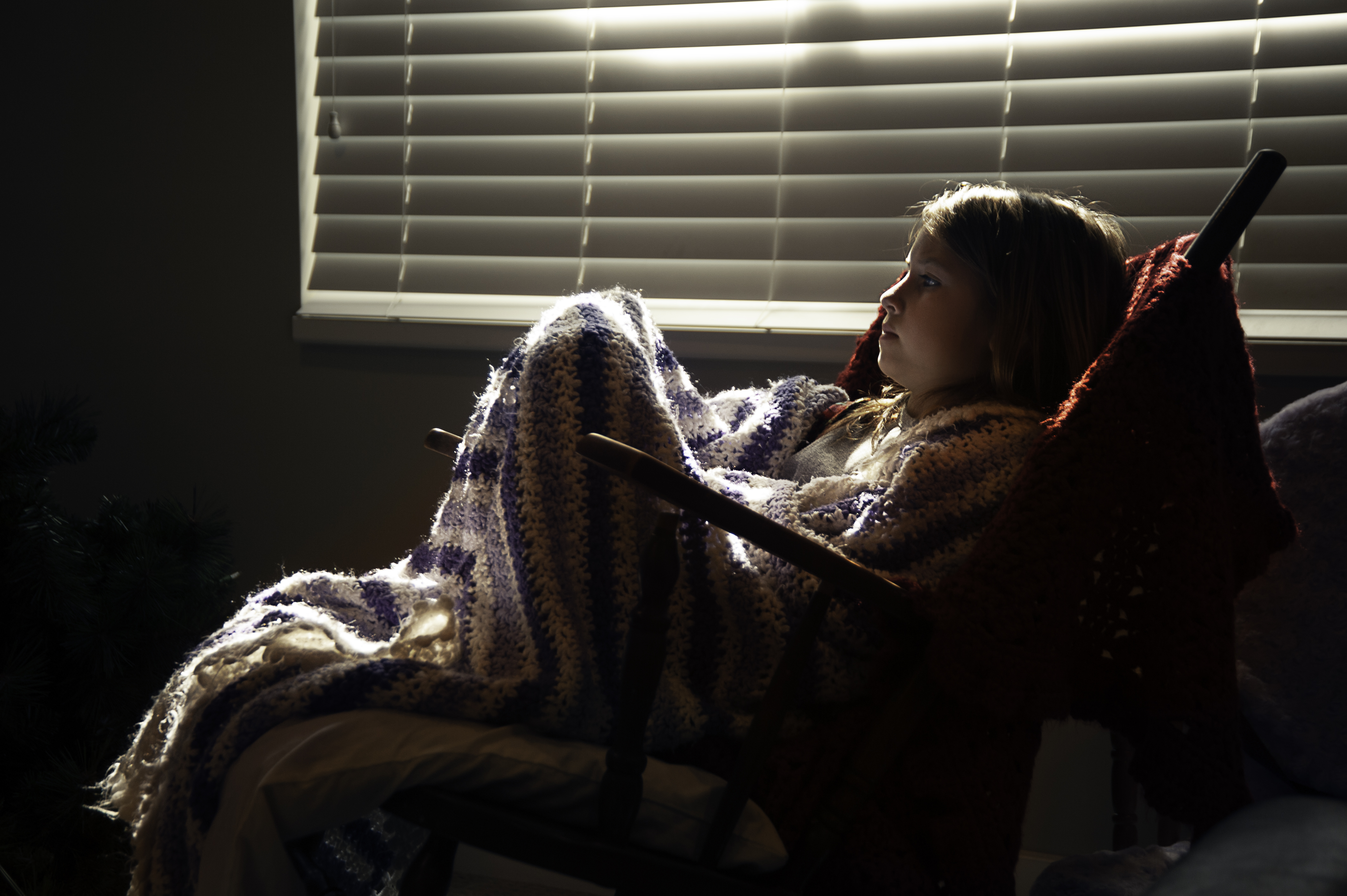 Katherine watching T.V. in a blanket